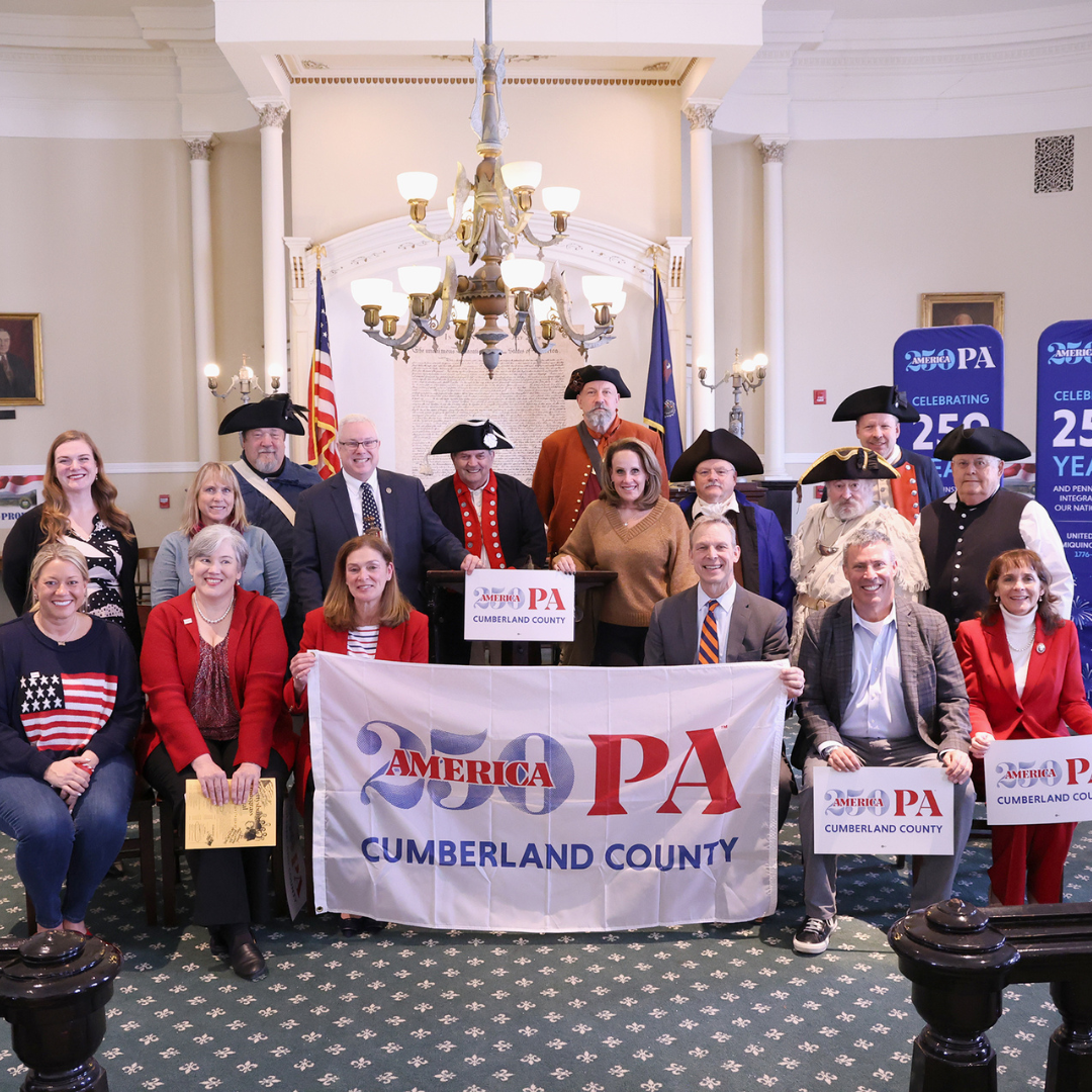Photo of officials holding up America250PA Cumberland County signs